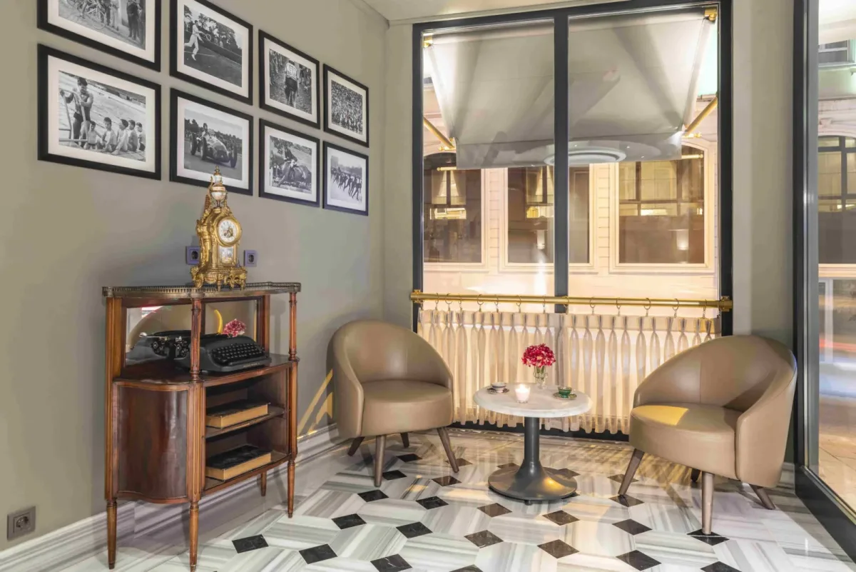 A corner of the Hotel Marius lobby with a wall of framed historic photographs, Sirkeci, Istanbul
