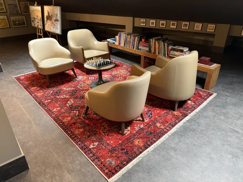 Reading corner with a chess table and art books in the Marius rooftop gallery