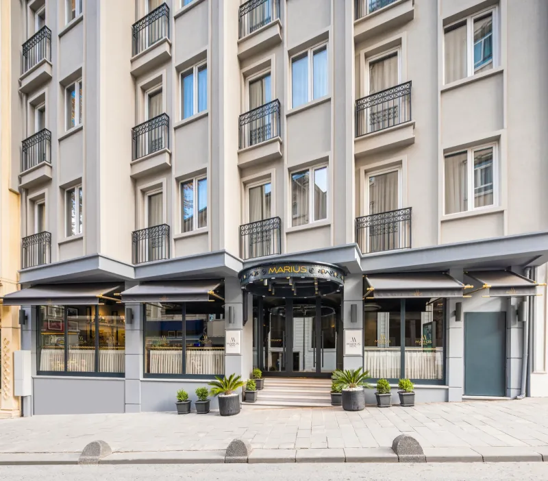 The Hotel Marius entrance with its round black canopy, by day