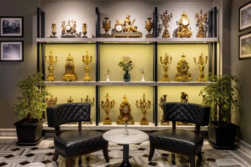 Antique clocks and armchairs in the Hotel Marius lobby
